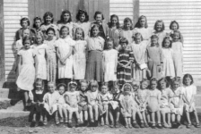 511: Group of 39 young ladies. (circa 1950) [courtesy of Lorna Richardson] ** also see 512 &amp;amp; 513 **  Standing in back row (top step) left-to-right, Imelda Ryan, Annie Norman, Marg Norman,  Marie Ryan, Angela Ryan, Gwen Carroll, Marie Counsel, Teresa Whelan, Beth Lambe, Kathleen Barry,  Teresa Norman; standing in second row from back (second step), Madonna McCarthy, Babe Ennis,  Mary Finn, Noreen Ryan, Mary Ennis, Madonna Whelan, Kathleen Lambe, unidentified,  Gert Ryan, Teresa Kerrivan, Lorraine Kerrivan, Anne Counsel; standing on first step, Mary Reddy;  sitting on first step left-to-right, ? Ennis, unidentified, Sheila Ryan (wearing bonnet),  unidentified (with white bow), unidentified, ? Ennis, Irene Webber, unidentified (dark dress),  unidentified (wearing white head covering), unidentified, Hilda Whelan, unidentified,  Rita Whelan, unidentified, Bernardine Whelan. ** more details below **  - Kathleen Barry (of Thomas Barry &amp;amp; Anne Dollimont)  - Gwen Carroll (of Michael Carroll &amp;amp; Josephine Barry)  - Anne Counsel (of Michael Counsel &amp;amp; Mary Anne Barry)  - Marie Counsel (of Michael Counsel &amp;amp; Mary Anne Barry)  - Babe Ennis (of Vincent Ennis &amp;amp; Mary Carroll)  - Mary Ennis (of Vincent Ennis &amp;amp; Mary Carroll)  - Mary Finn (of Patrick Finn &amp;amp; Helena Hayward)  - Lorraine Kerrivan (of James Kerrivan &amp;amp; Josephine Norman)  - Teresa Kerrivan (of Peter Kerrivan &amp;amp; Cecilia Cheeseman)  - Beth Lambe (of James Lambe &amp;amp; Catherine Rodgers)  - Kathleen Lambe (of James Lambe &amp;amp; Catherine Rodgers)  - Madonna McCarthy (of James McCarthy &amp;amp; Mary Ellen Barry)  - Annie Norman (of John Norman &amp;amp; Mary Farget)  - Marg Norman (of Charles Norman &amp;amp; Elizabeth Anne Barry)  - Teresa Norman (of Peter Norman &amp;amp; Margaret Norman)  - Mary Reddy (of Michael Reddy &amp;amp; Elizabeth Moore)  - Angela Ryan (of Michael Ryan &amp;amp; Petronella Whelan)  - Gert Ryan (of Jeremiah Ryan &amp;amp; Josephine Lambe)  - Imelda Ryan (of Jeremiah Ryan &amp;amp; Josephine Lambe)  - Marie Ryan (of Joseph Ryan &amp;amp; Ursula Barry)  - Noreen Ryan (of Albert Ryan &amp;amp; Catherine Nolan)  - Sheila Ryan (of Albert Ryan &amp;amp; Catherine Nolan)  - Irene Webber (of William Webber &amp;amp; Anne Counsel)  - Bernardine Whelan (of Leo Whelan &amp;amp; Elizabeth Bishop)  - Hilda Whelan (of Leo Whelan &amp;amp; Elizabeth Bishop)  - Madonna Whelan (of Leo Whelan &amp;amp; Elizabeth Bishop)  - Rita Whelan (of Leo Whelan &amp;amp; Elizabeth Bishop)  - Teresa Whelan (of Leo Whelan &amp;amp; Elizabeth Bishop)